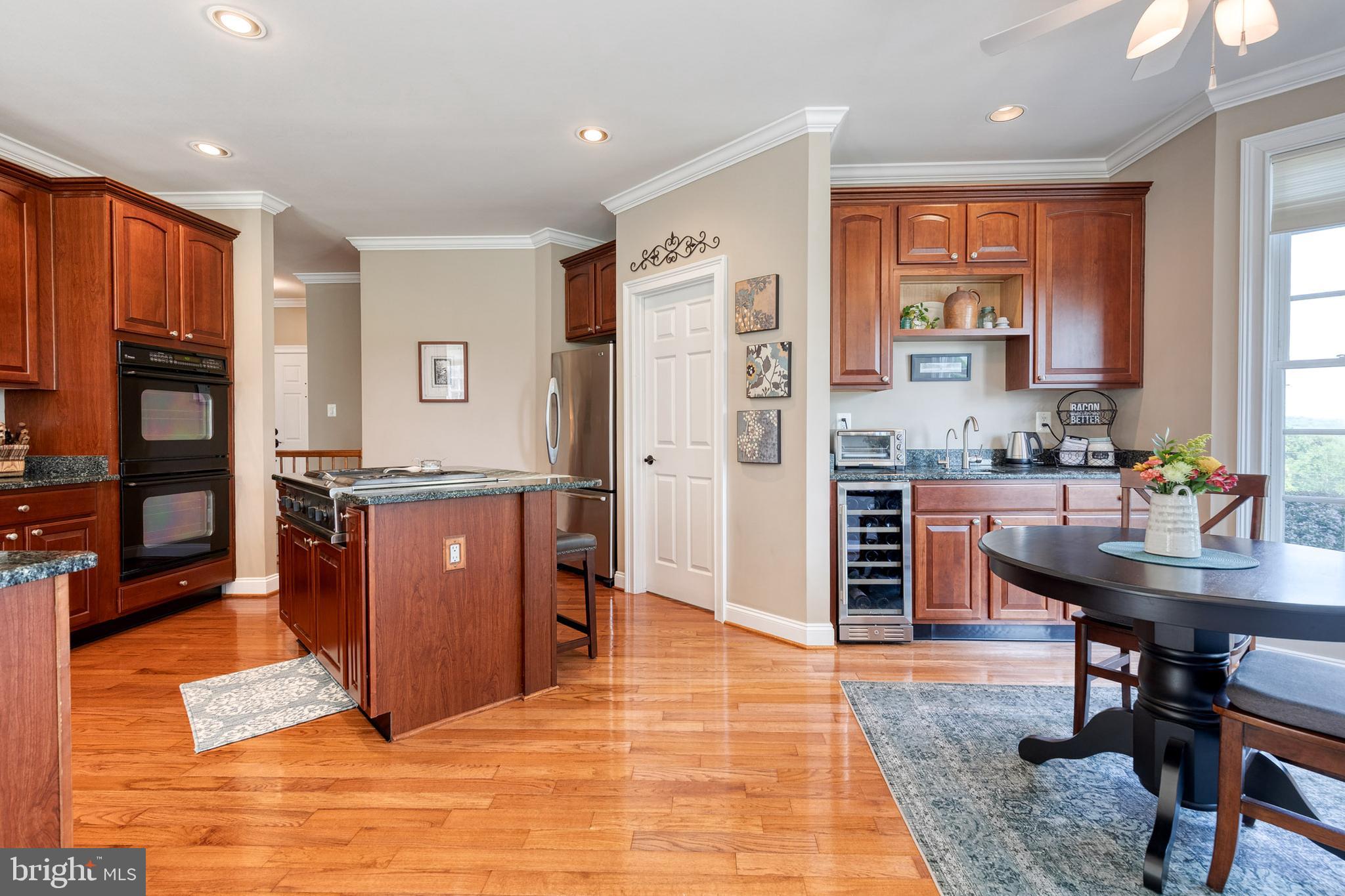 14942 Dover Road Reisterstown, MD 21136 - Photo 15 of 47 a view of kitchen with stainless steel appliances granite countertop cabinets and a dining table