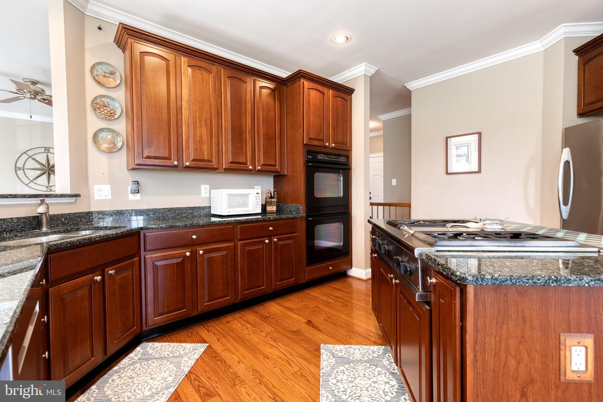 14942 Dover Road Reisterstown, MD 21136 - Photo 16 of 47 a kitchen with stainless steel appliances granite countertop a stove a sink and a microwave