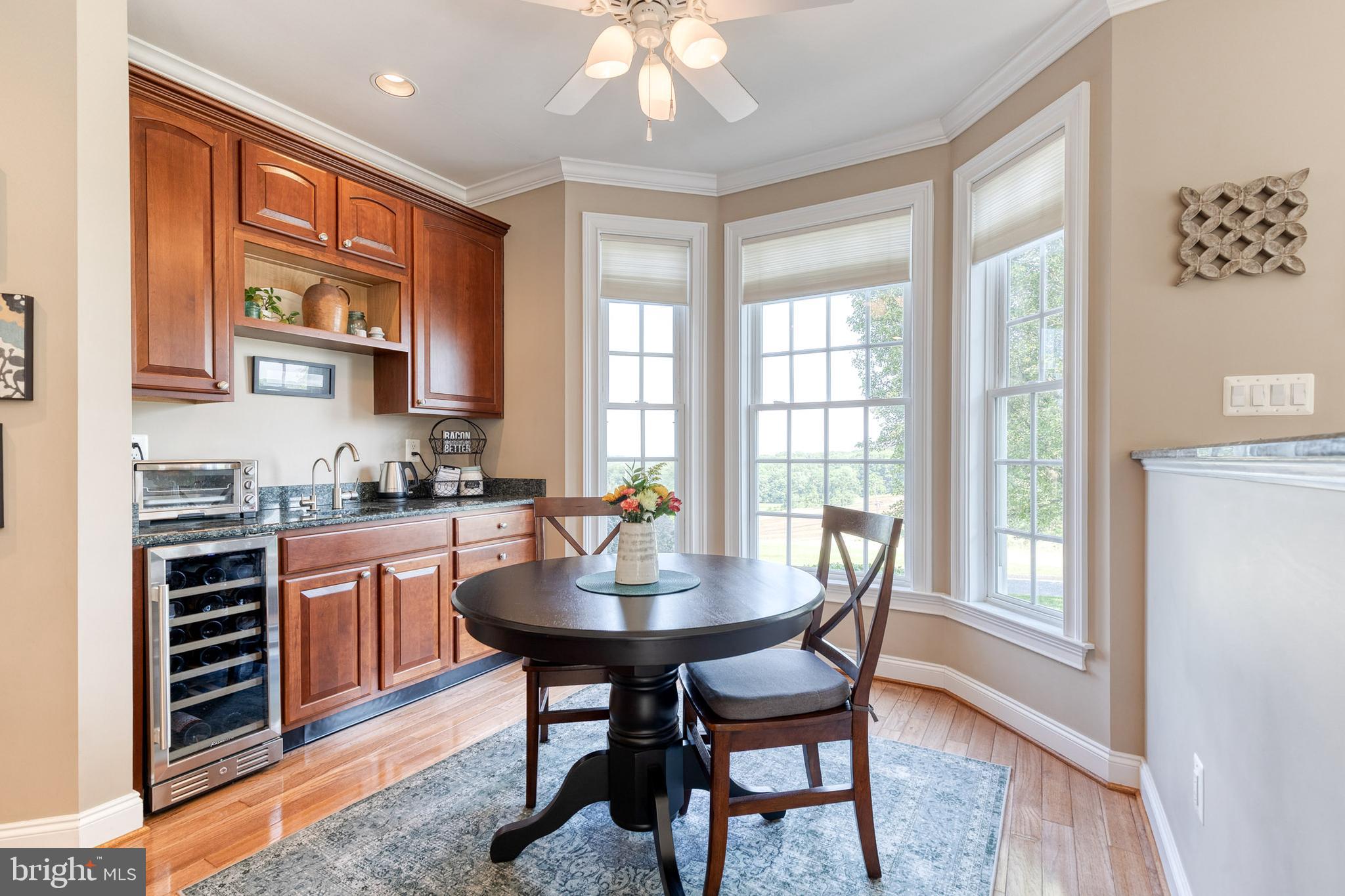 14942 Dover Road Reisterstown, MD 21136 - Photo 19 of 47 a kitchen with stainless steel appliances granite countertop a stove top oven a sink dishwasher and a dining table with garden view