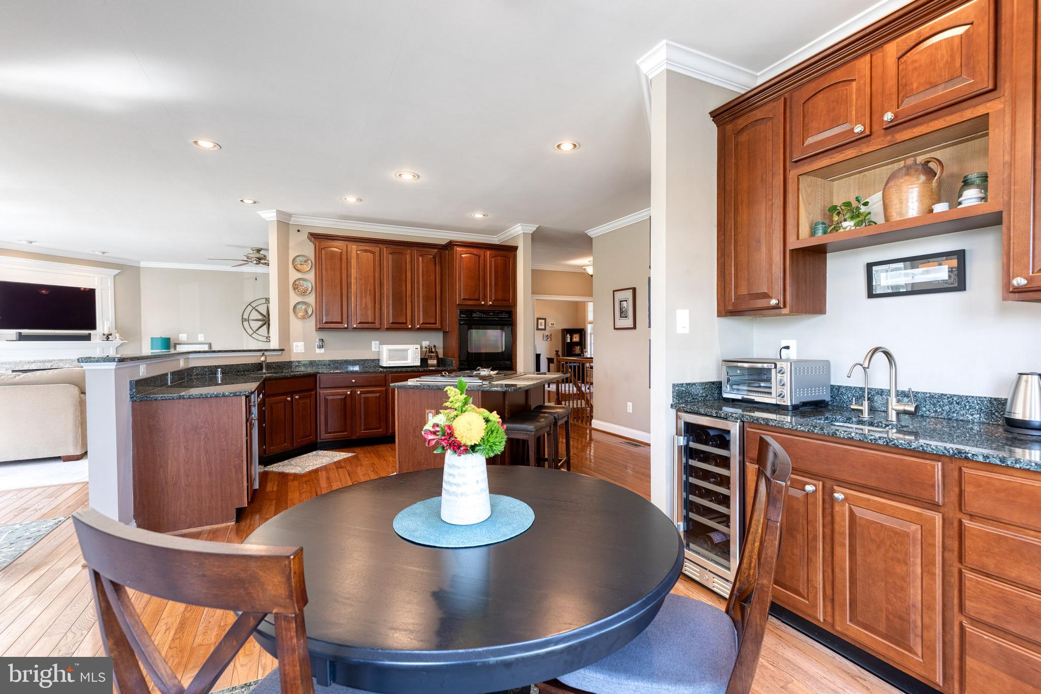14942 Dover Road Reisterstown, MD 21136 - Photo 20 of 47 a kitchen with granite countertop a sink dining table and chairs