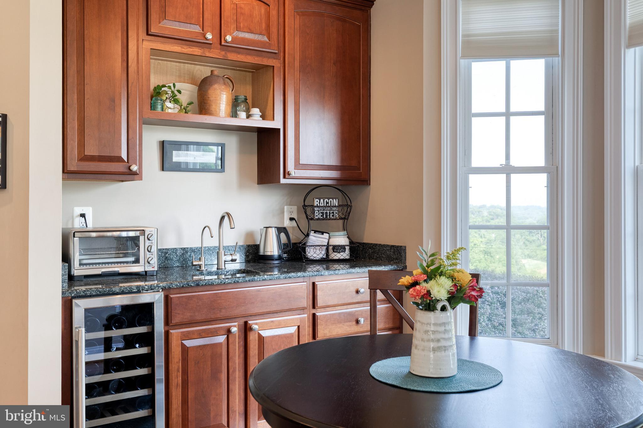 14942 Dover Road Reisterstown, MD 21136 - Photo 21 of 47 a kitchen with a stove a sink and a potted plant