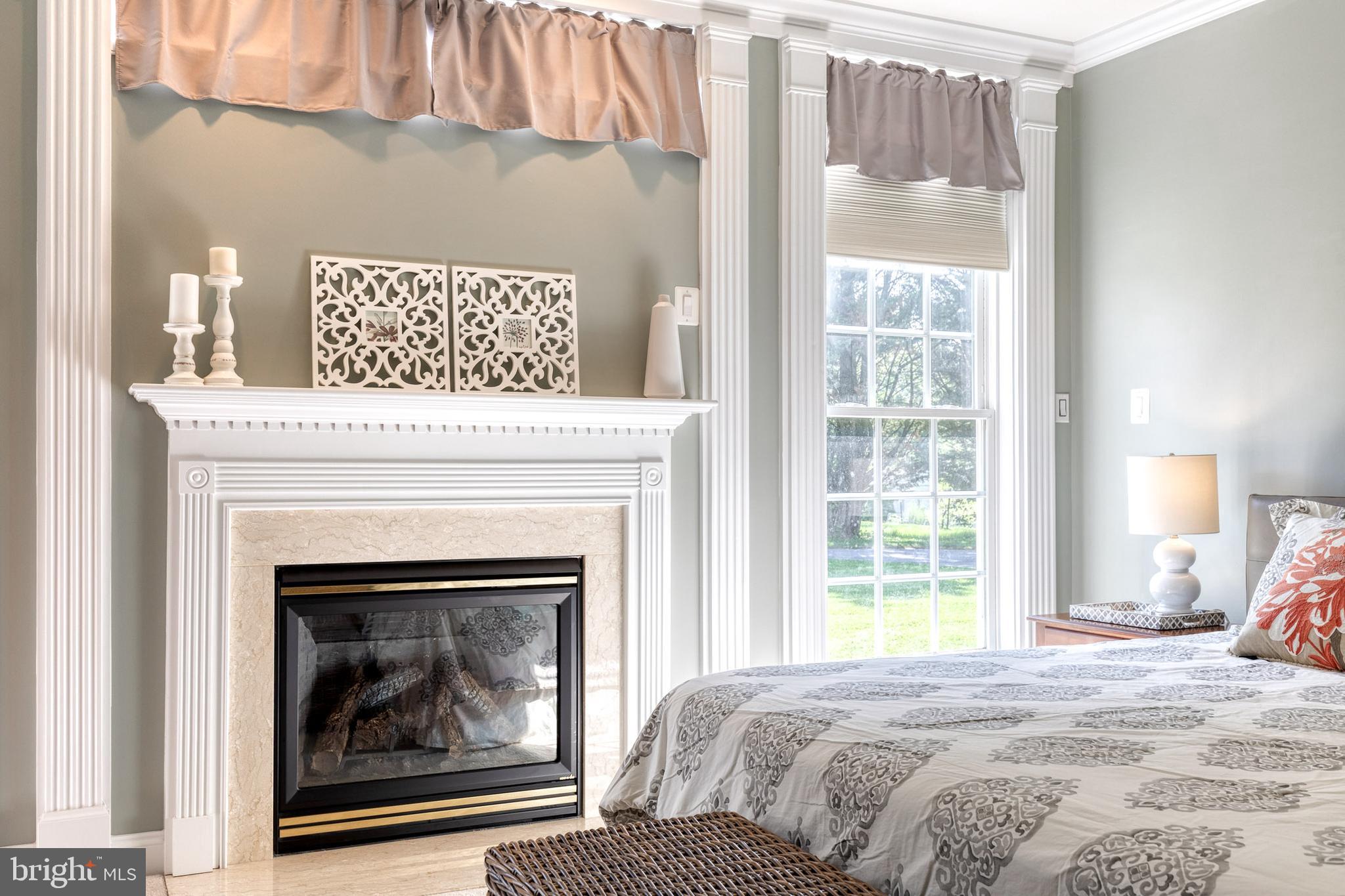 14942 Dover Road Reisterstown, MD 21136 - Photo 27 of 47 a bedroom with a bed and a fireplace
