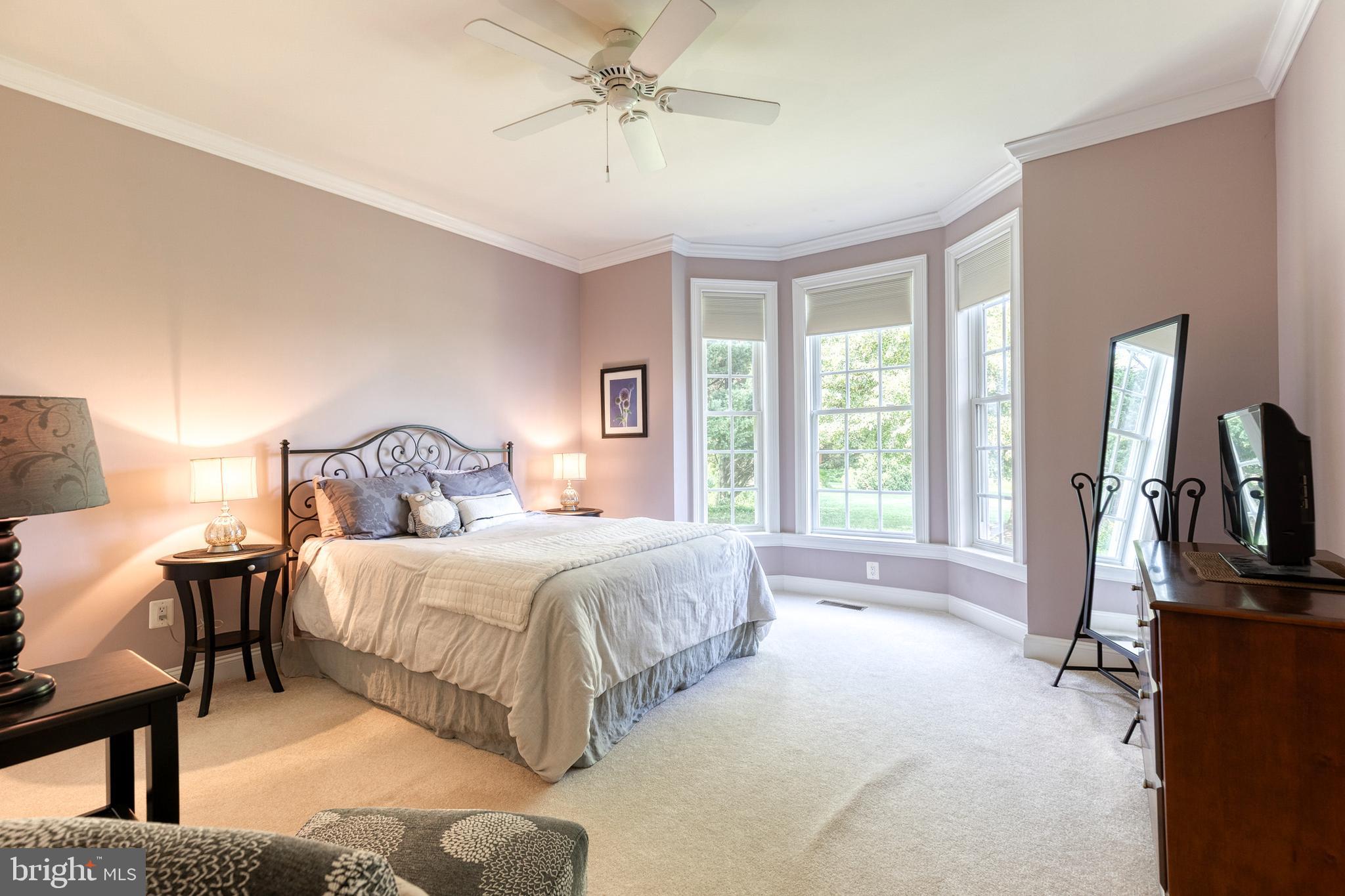 14942 Dover Road Reisterstown, MD 21136 - Photo 32 of 47 a bedroom with a bed flat screen tv and a large window