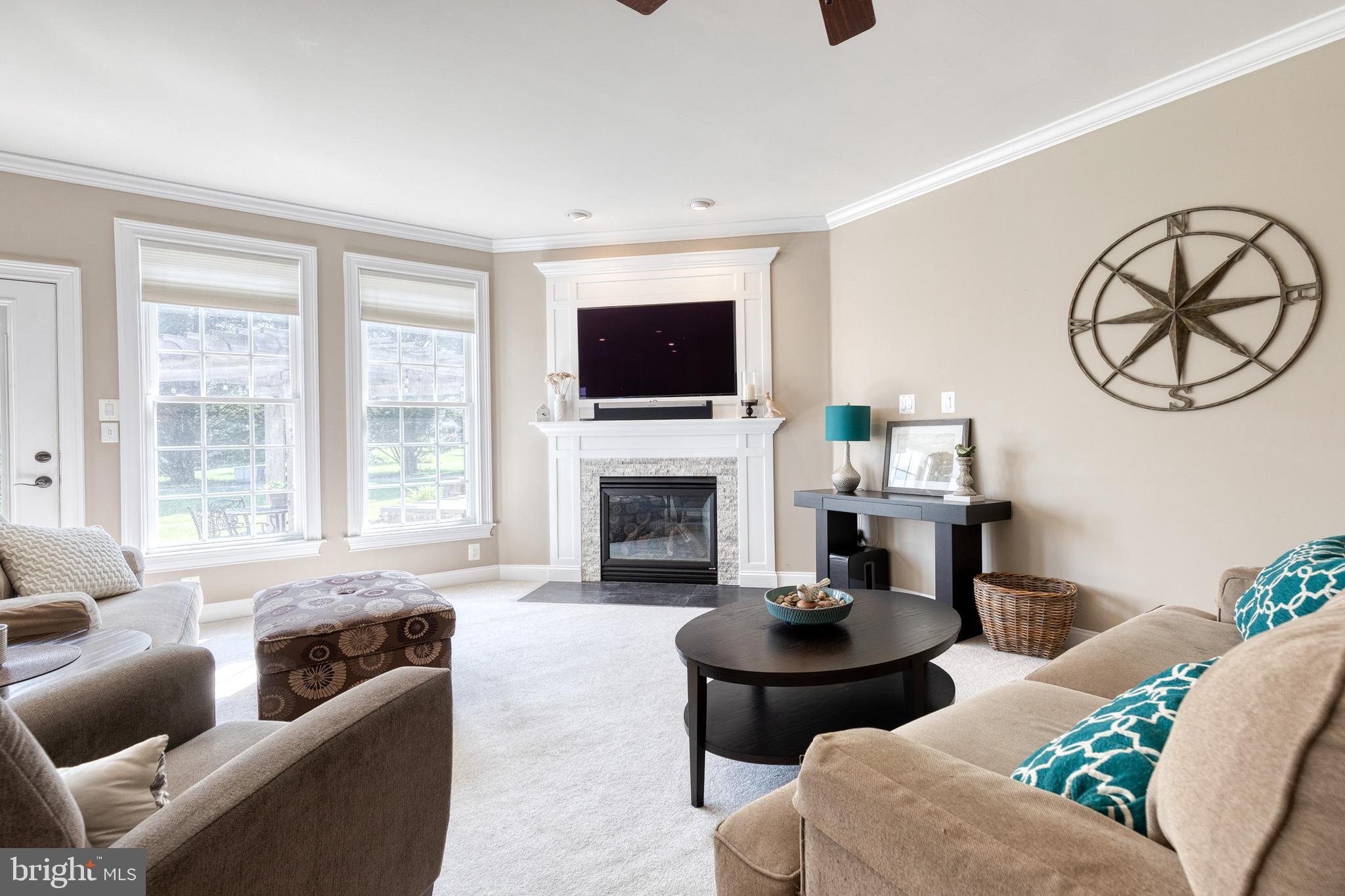 14942 Dover Road Reisterstown, MD 21136 - Photo 5 of 47 a living room with furniture a flat screen tv and a fireplace