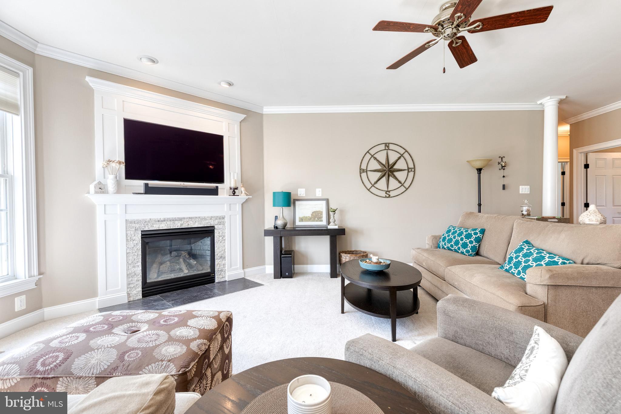 14942 Dover Road Reisterstown, MD 21136 - Photo 6 of 47 a living room with furniture a flat screen tv and a fireplace