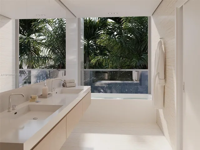 a bathroom with a tub sink and mirror