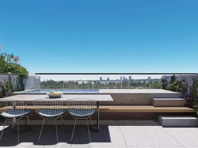 a balcony with a table and chairs