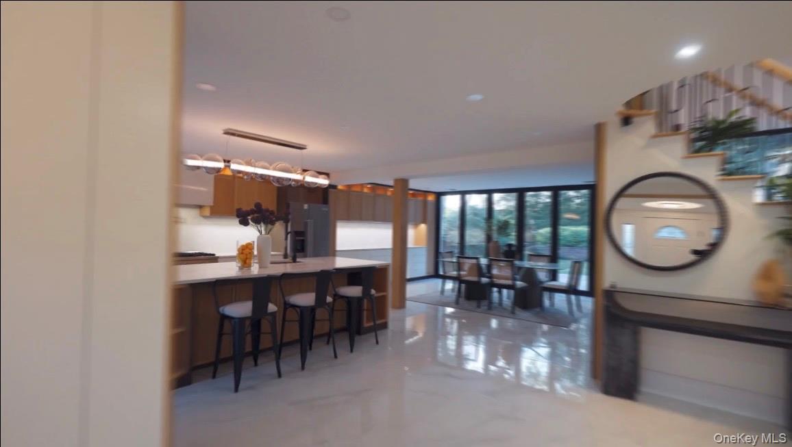 21 Wesleyan Road Commack, NY 11725 - Photo 3 of 9 a kitchen with a dining table chairs and white walls
