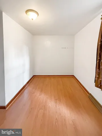 a view of room with wooden floor