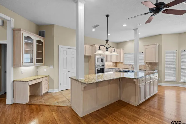 a kitchen with stainless steel appliances granite countertop a sink stove and cabinets
