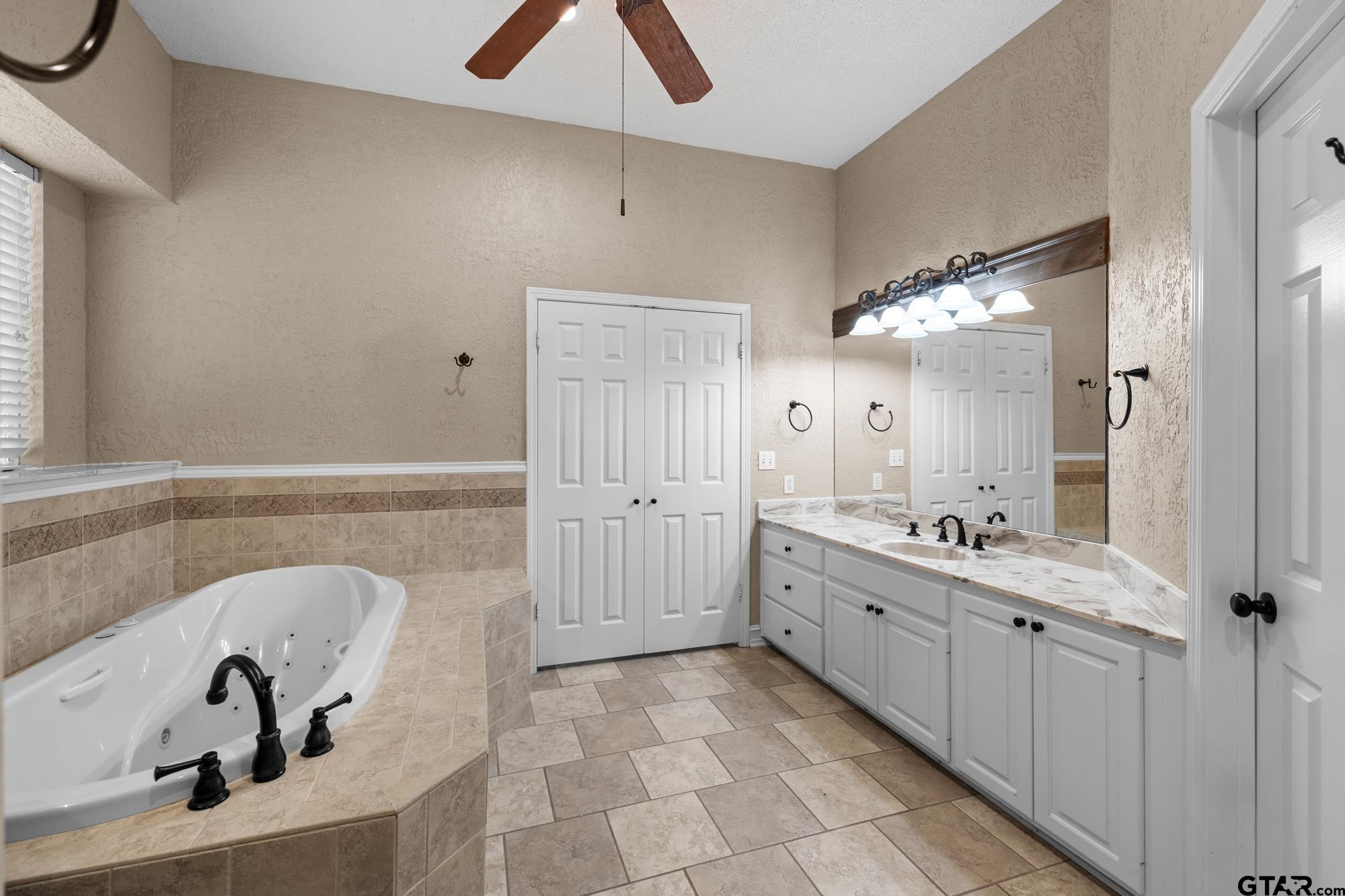 210 Lavender Lane Longview, TX 75605 - Photo 23 of 36 a bathroom with a double vanity sink and mirror