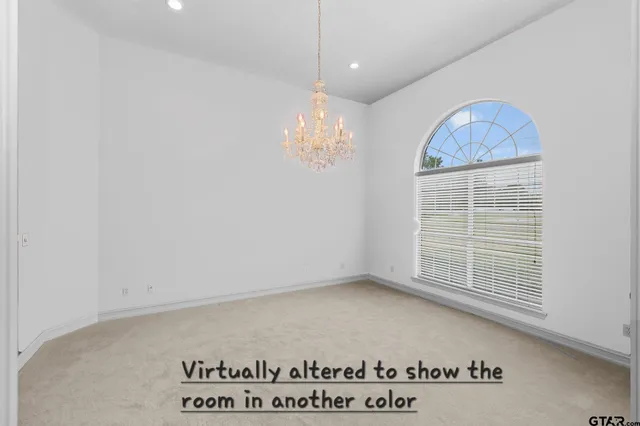 a view of an empty room with a fireplace and a window