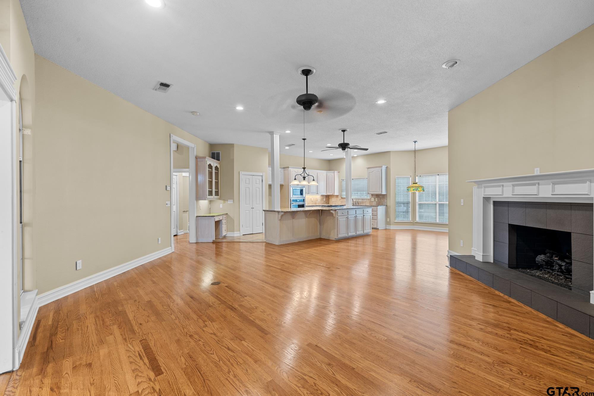 210 Lavender Lane Longview, TX 75605 - Photo 10 of 36 a view of a kitchen and an empty room with wooden floor