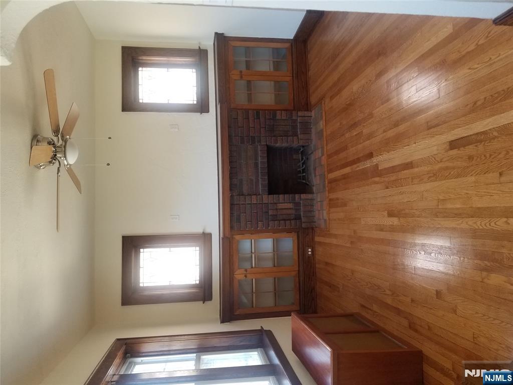 130-2 Rutherford Place, Unit 2L North Arlington, NJ 07031 - Photo 2 of 11 a room with wooden floor and windows