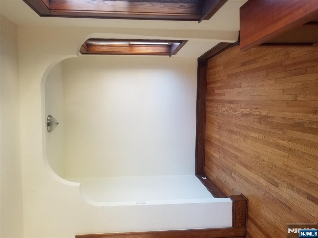 130-2 Rutherford Place, Unit 2L North Arlington, NJ 07031 - Photo 3 of 11 a view of an empty room with wooden floor and a window