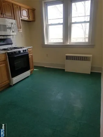 a kitchen with a stove a sink and a microwave