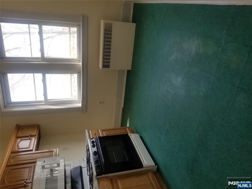 130-2 Rutherford Place, Unit 2L North Arlington, NJ 07031 - Photo 7 of 11 a kitchen with a stove a sink and a microwave