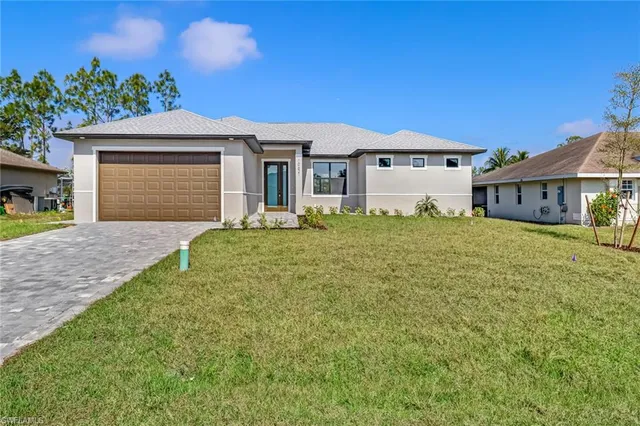 a front view of a house with a yard and garage