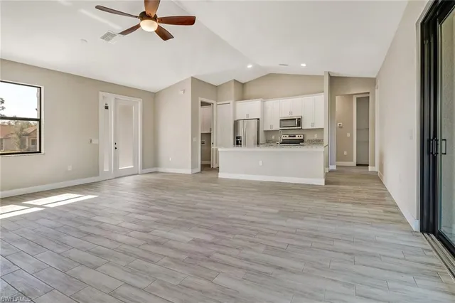 a view of a kitchen with a sink and cabinets