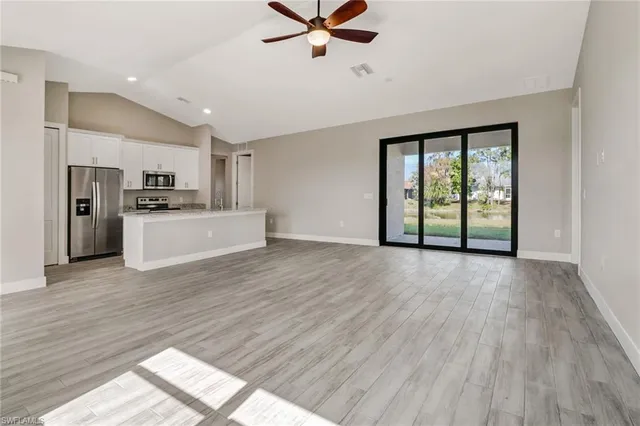 a view of a kitchen with a stove cabinets and wooden floor