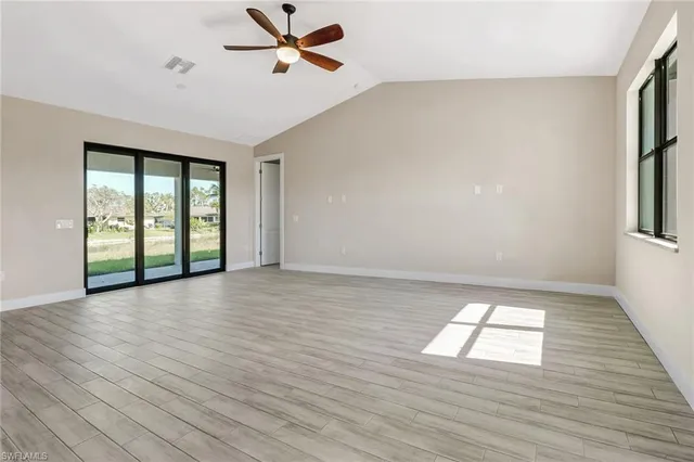wooden floor in an empty room with a window