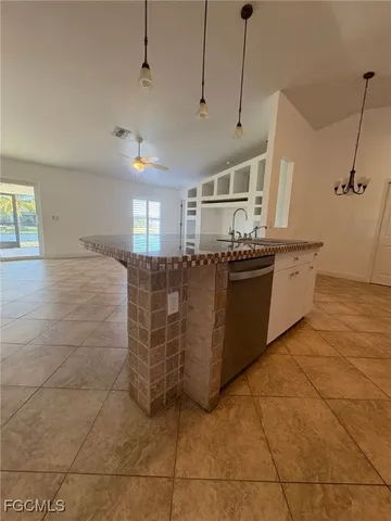 a kitchen with stainless steel appliances granite countertop a sink and cabinets