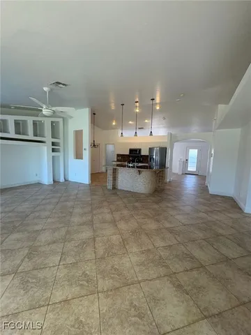 a view of a living room and kitchen
