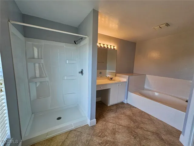 a bathroom with a bathtub and a shower