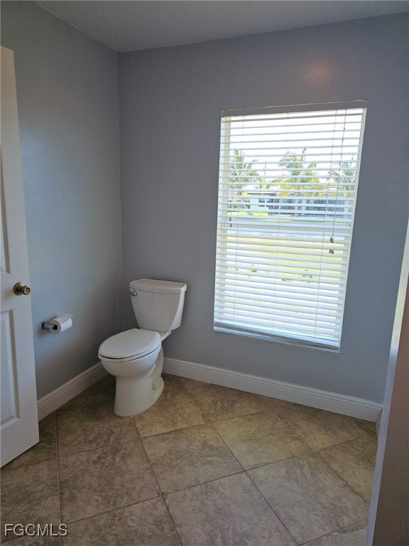 1502 Southwest 20th Avenue Cape Coral, FL 33991 - Photo 18 of 31 a bathroom with a toilet sink and window