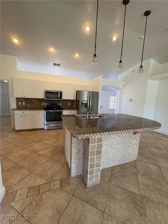1502 Southwest 20th Avenue Cape Coral, FL 33991 - Photo 7 of 31 a kitchen with stainless steel appliances granite countertop a stove a sink a oven and a granite counter tops