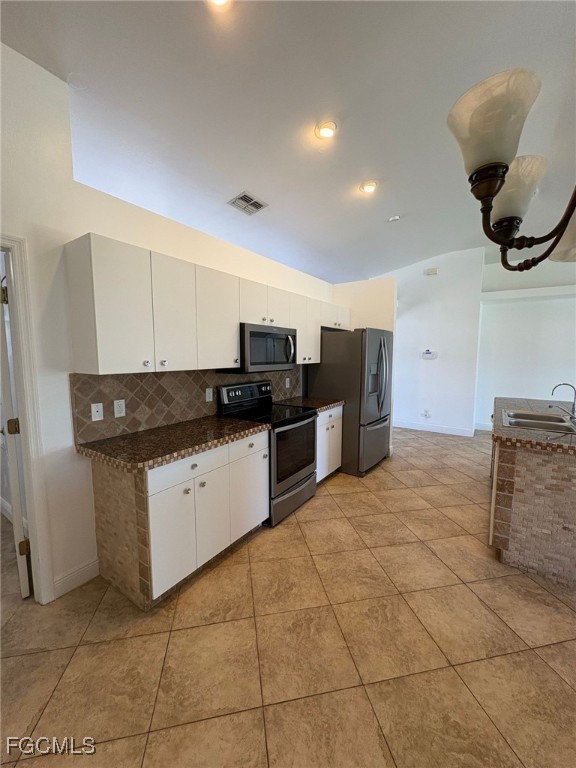 1502 Southwest 20th Avenue Cape Coral, FL 33991 - Photo 10 of 31 a kitchen with stainless steel appliances granite countertop a sink and cabinets