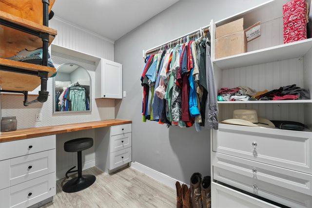a bedroom with a bed wooden floor and window