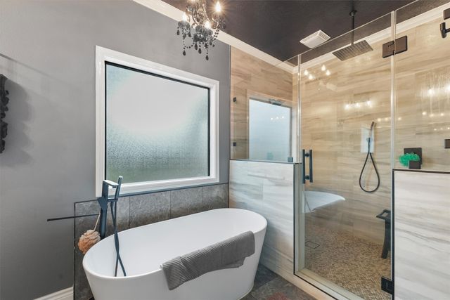 a bathroom with a tub a double vanity sink and mirror