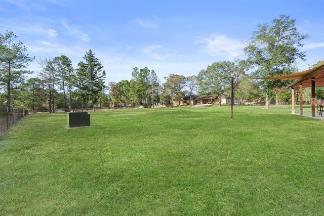 a view of a patio with a table chairs and a swimming pool
