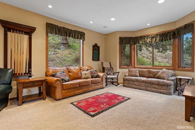a living room with furniture and large windows
