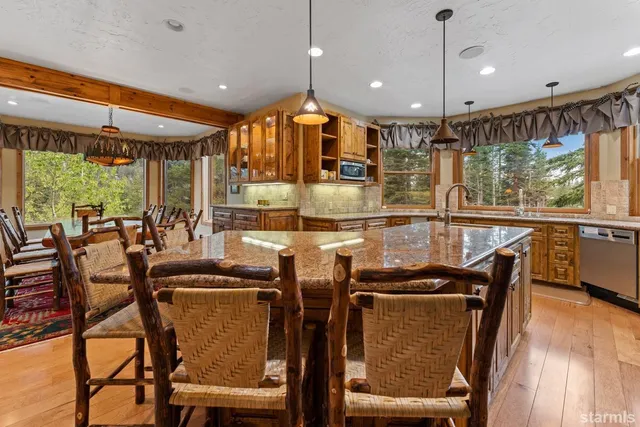 a large kitchen with a table and chairs