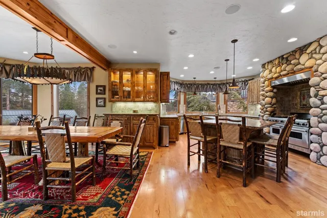 a view of a dining room with furniture and chandelier