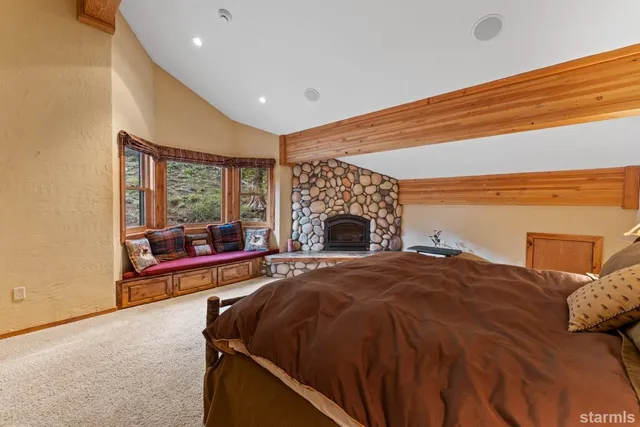 a spacious bathroom with a granite countertop double vanity sink a mirror and a bathtub