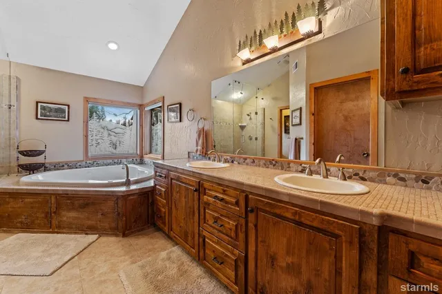 a bathroom with a tub a sink and a shower