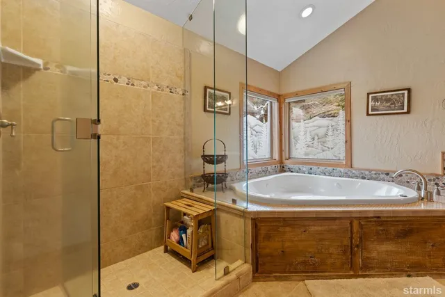 a spacious bathroom with a double vanity sink a mirror and a