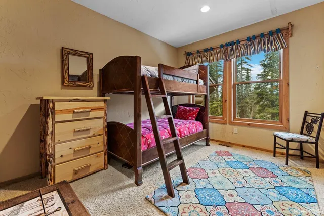 a bathroom with a double vanity sink toilet mirror and bathtub