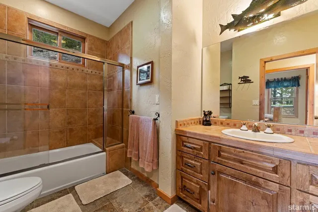 a spacious bedroom with a bed and a large window