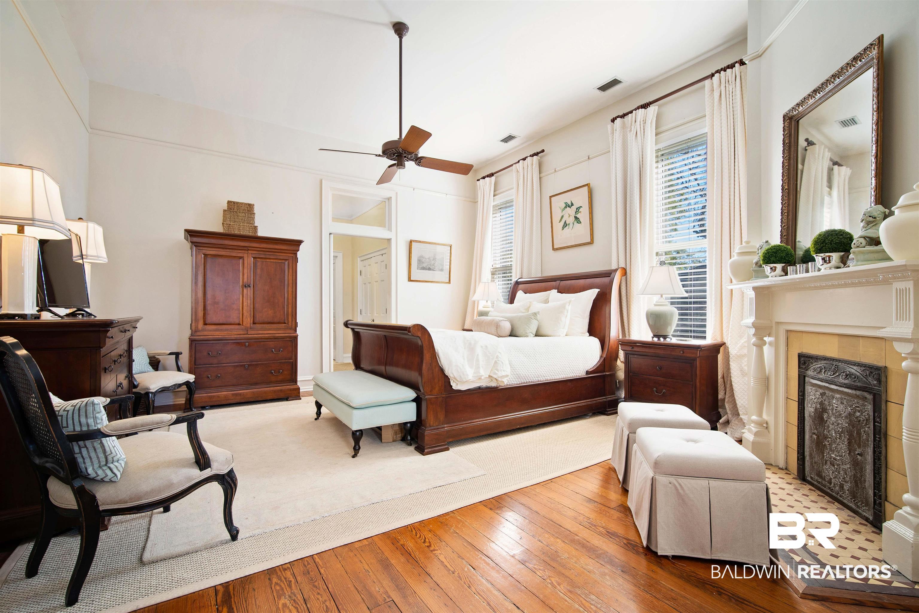 1314 Dauphin Street Mobile, AL 36604 - Photo 35 of 61 Bedroom with ceiling fan, light hardwood floors, and a summer front fireplace