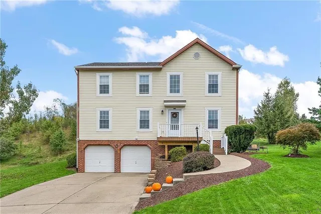 a front view of a house with a yard