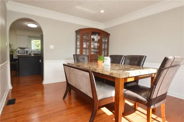 a view of a dining room with furniture and wooden floor