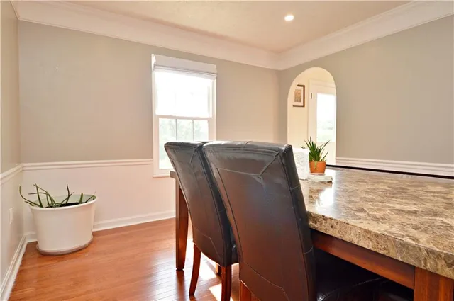 a view of a dining room with furniture and a window