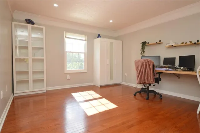a view of workspace with wooden floor windows