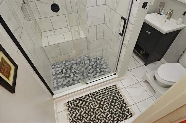 a bathroom with a sink toilet and shower