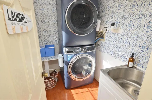a close view of a sink and a washer in a bathroom