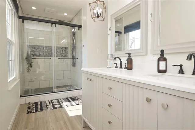 a bathroom with a shower sink and mirror